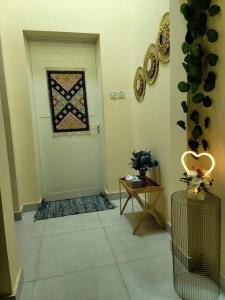 a hallway with a door with a window on it at Villa Ria RAK in Ras al Khaimah