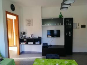 a living room with a tv on a wall at Casa MaryGiò in San Giovanni Teatino