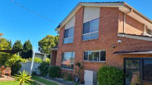 a brick house with solar panels on it at Clayton Living Town House at Monash Doorstep in Clayton North