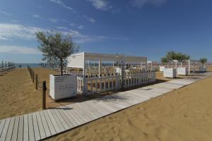 a building on the beach next to a sandy beach at Hotel Las Vegas in Bibione +66 photos