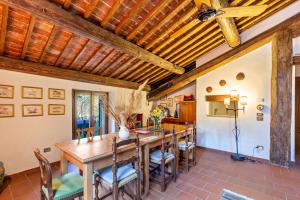 a dining room with a wooden table and chairs at Casa Rossa Vendri in Verona