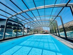 an indoor swimming pool with a glass ceiling at Haus Leitner in Attersee am Attersee