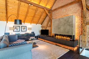 a living room with a fireplace and a couch at Rebenhaus Loft in Baden-Baden