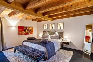 a bedroom with a large bed and a wooden ceiling at Rebenhaus Loft in Baden-Baden