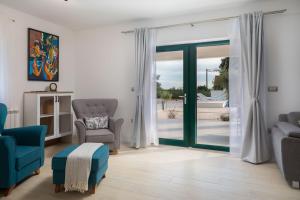 a living room with a sliding glass door at Tosic Estate - Villa, Vineyards and Winery in Razvođe +49 photos