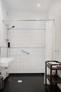 a bathroom with a sink and a shower curtain at Stadsparken Apartments in Helsingborg