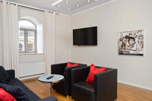 a living room with a couch and a table at Stadsparken Apartments in Helsingborg
