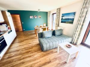 a living room with a couch and a table at Haus Leitner in Attersee am Attersee