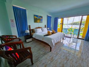 a bedroom with a bed with two teddy bears on it at Lanta MP Place in Ko Lanta