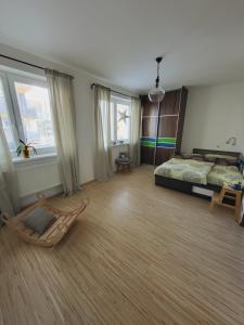 a bedroom with a bed and a chair in a room at Tatry Mountain Paradise in Poprad