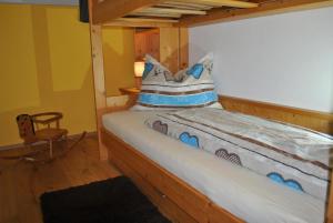 a bed in a wooden room with a pillow at Ferienwohnung Gipfelblick in Weerberg