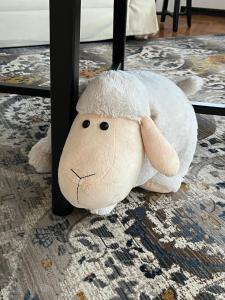 a stuffed animal sitting on the floor next to a table at Hillside Luxury Residence Budapest with free garage in Budapest