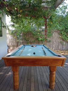 a pool table sitting on a wooden deck at 1 Croft Cottage, in Knysna
