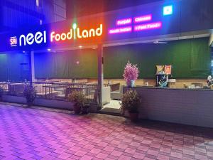 a restaurant with a meal food land sign at night at Hotel 9 Coin in Shirdi