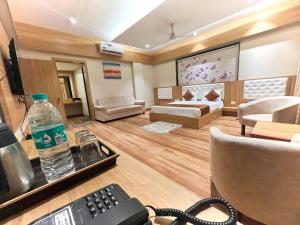 a room with a remote control and a room with a bed at Hotel 9 Coin in Shirdi