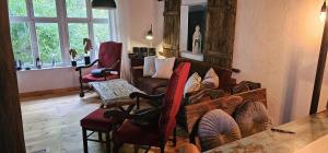 a living room with a couch and chairs and a table at Ferienhaus am Haff in Hintersee