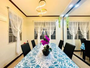 a dining room with a blue and white table with a plant at Hidden Gem: Cebu's Best Escape in Talisay