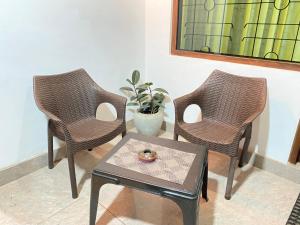 two chairs and a table with a coffee table at Fortuna Villa in Hikkaduwa