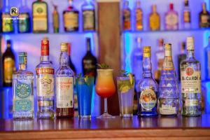 a bunch of bottles of alcohol sitting on a bar at Kabalega Resort - Masindi in Masindi