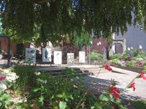 a cemetery with tombestones and flowers in front of a building at Le Q'vier in Montbéliard