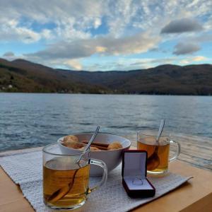 a table with a bowl of food and two glasses of beer at Splav Wake at the lake in Gaočići