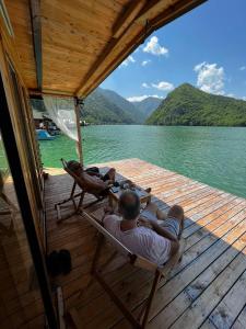 two people laying on the deck of a boat at Splav Wake at the lake in Gaočići +33 photos