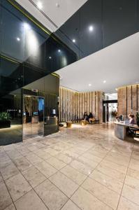 een lobby met een grote kamer met mensen erin bij Level 59 Delightful City Central 3B2B1C Apartment in Melbourne