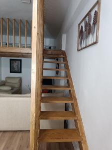 a wooden staircase leading up to a loft bed at MCR in Isla Cristina