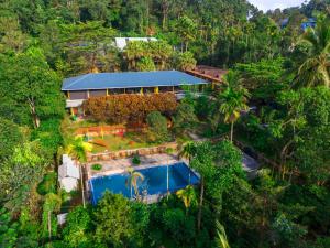 an aerial view of a house in the forest at The Hosteller Wayanad in Vythiri