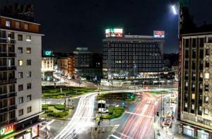 a busy city street at night with buildings and cars at Panoramic Plaza Apartment -Loreto 1 in Milan