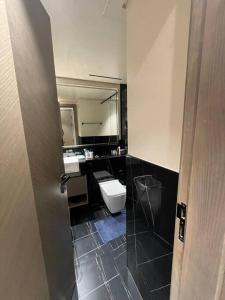 a bathroom with a toilet and a sink at 1BHK smart home - Downtown Dubai in Dubai