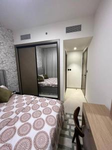 a bedroom with a bed and a room with a mirror at 1BHK smart home - Downtown Dubai in Dubai