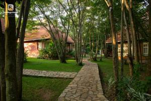 a path in front of a house with trees at Kabalega Resort - Hoima in Hoima