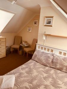 1 dormitorio con 1 cama, mesa y sillas en Cunard Guest House, en Weymouth