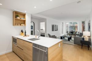 New build, modern 1bed+den with fitness room, minutes to Downtown! في فيكتوريا: مطبخ مع حوض وغرفة معيشة