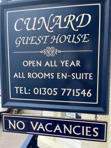 a sign for a guest house on the side of a building at Cunard Guest House in Weymouth