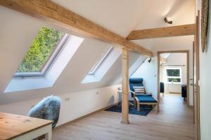 an attic room with skylights and a table and chairs at Haus Wiesenruhe in Seebach