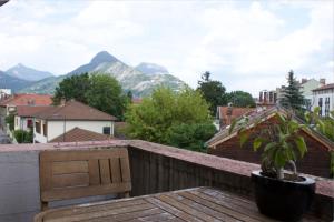 a balcony with a bench and mountains in the background at 3 min sortie A480: wifi fibre - lit bébé - balcon in Grenoble