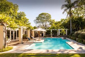 an image of a swimming pool in a backyard at Guest suite - Leafy Constantia Guest House in Cape Town