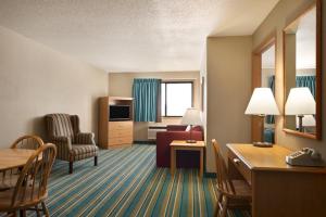 a hotel room with a living room at Coratel Inn & Suites by Jasper New Richmond in New Richmond