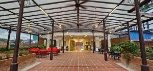an outdoor patio with awning and tables and chairs at Maison Signature Suites in Kuala Lumpur
