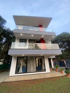a house with a large window on the side of it at West Valley Villa , Casa Raywood in Lonavala