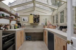 a kitchen with a sink and a large window at MAISON MOUZ in Paris