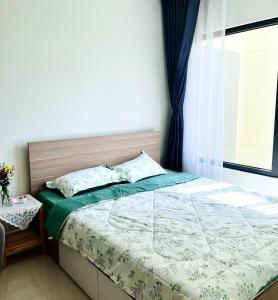 Schlafzimmer mit einem Bett und einem Fenster in der Unterkunft Vin Grand Park - TP. Thủ Đức in Tân Vạn
