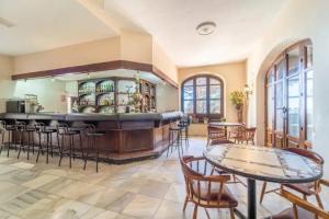 a kitchen with a bar and tables and chairs at Mansion Alhamar in Sitio de Calahonda