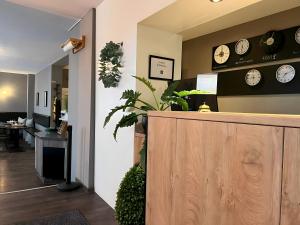 an office with clocks on the wall and a counter at Apartment Hotel Lindeneck in Erfurt