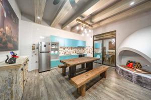 a kitchen with a wooden table and a refrigerator at 精彩奇寓站前電梯主題民宿走路到車站好停車 in Hualien City