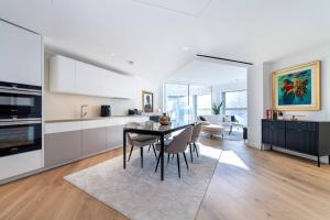 a kitchen and dining room with a table and chairs at Fantastic immense 1 BR flat, Battersea Power St in London