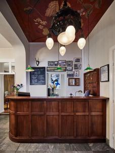 a restaurant with a counter with lights above it at Grand Hôtel Mölle in Mölle