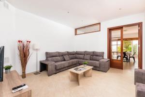 a living room with a couch and a table at Ca Na Bel 4 bedroom house, Ciutadella in Ciutadella